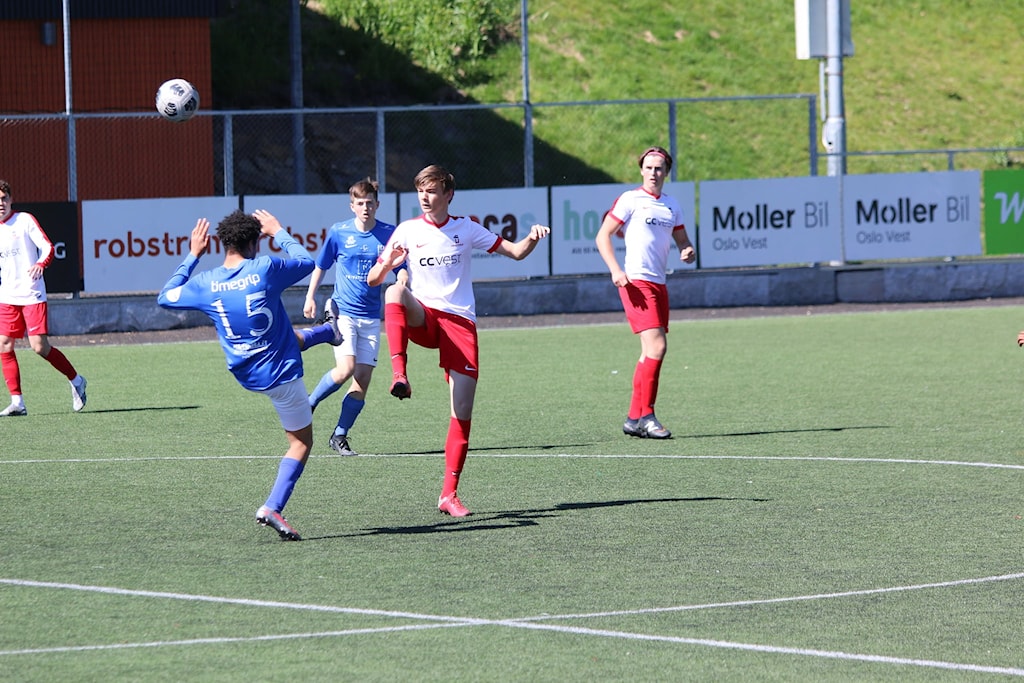 May be an image of 2 people, people standing, people playing football and grass