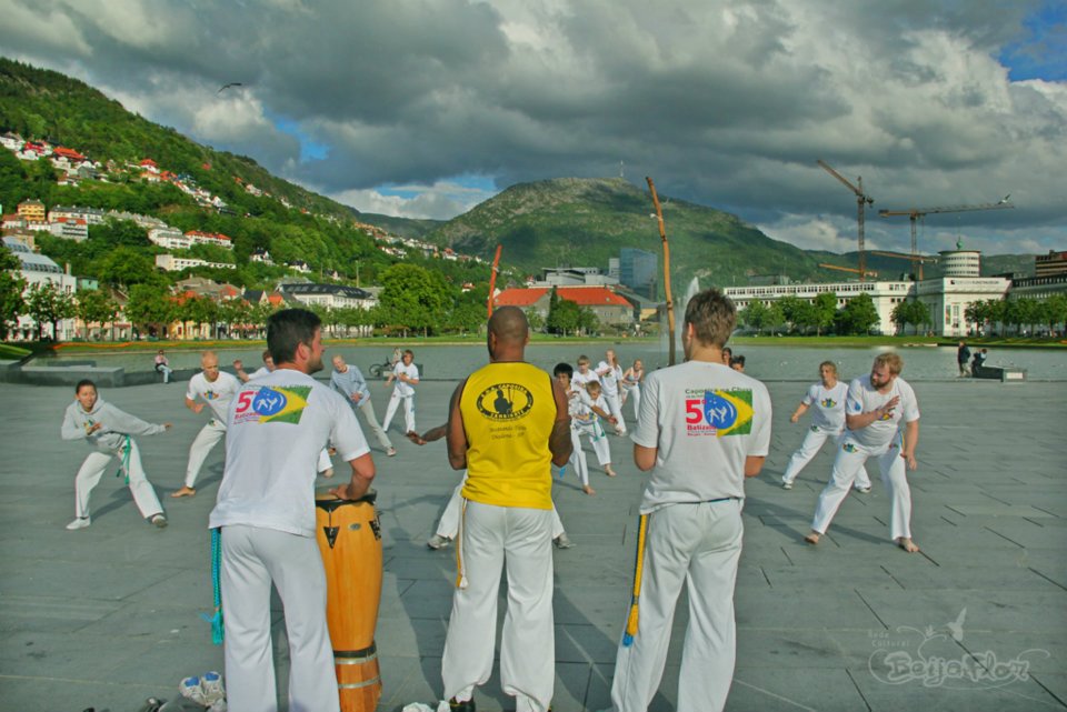 Image of Capoeira dancers in white clothes, on a dance practice outside