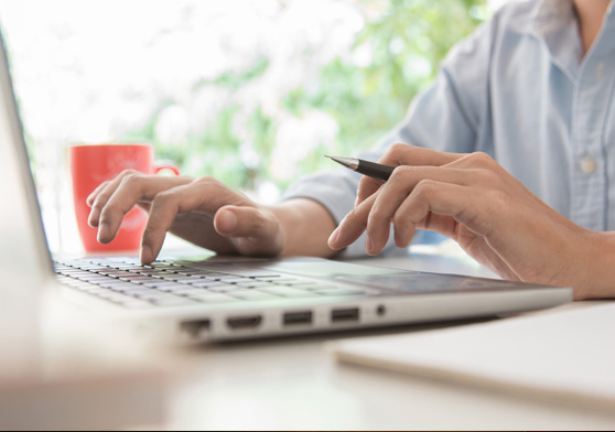 Image of someone typing on the computer